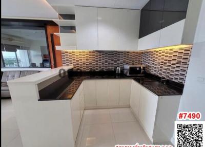 Modern kitchen with tiled backsplash and bar countertop