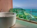 Modern bathroom with freestanding bathtub and panoramic sea view