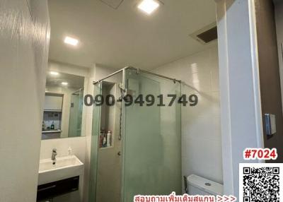 Modern bathroom with glass shower unit and white fixtures