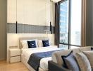 Modern bedroom with large bed, city view, and comfortable furnishings