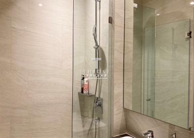 Modern bathroom interior with walk-in shower and glass partition