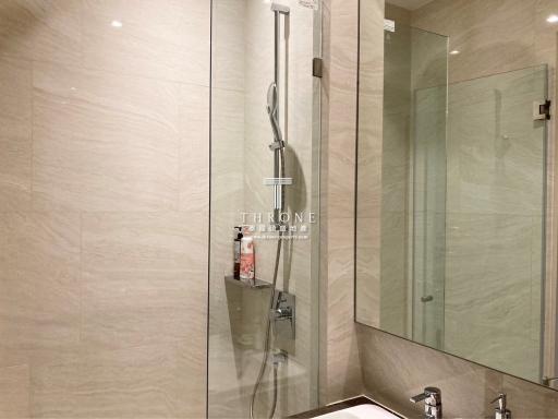 Modern bathroom interior with walk-in shower and glass partition