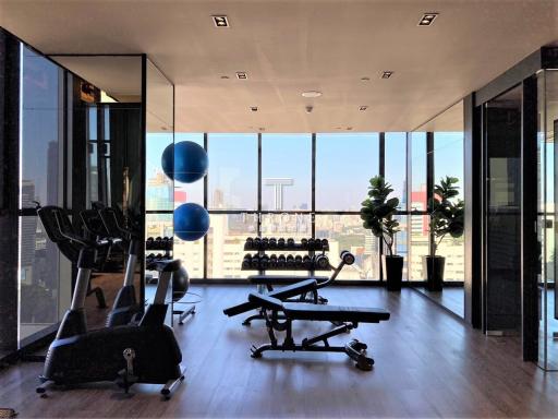 Spacious home gym with modern equipment and city view