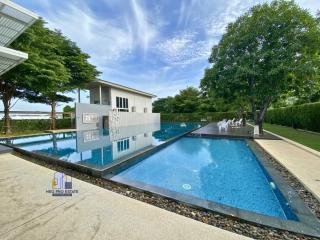 Spacious outdoor swimming pool with a serene garden view