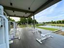 Outdoor gym equipment overlooking a serene pond in a residential area