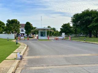 Guarded entrance to a residential community with lush greenery