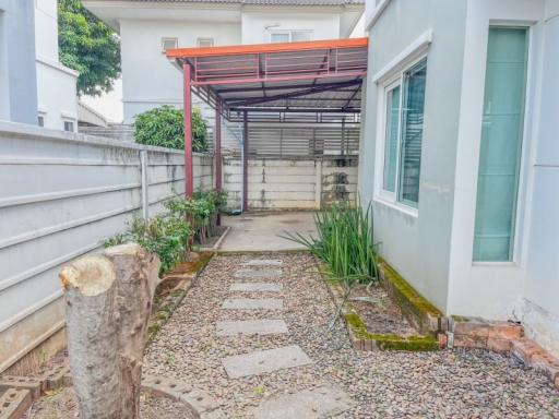 Cozy home exterior with walkway and carport