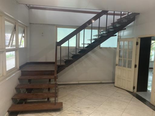 Interior view of a home with a staircase and tiled flooring