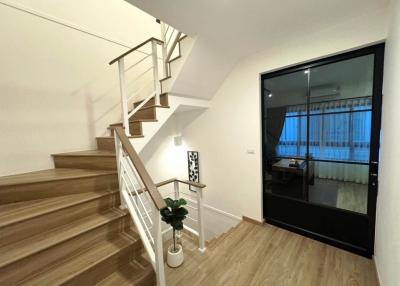 Modern staircase with glass railing inside a residential home