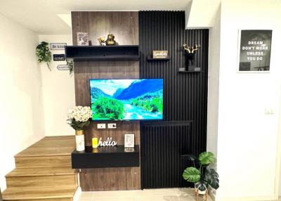 Modern living room interior with mounted television and decorative shelving