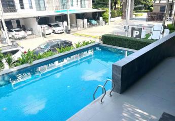 Outdoor swimming pool with apartment buildings in the background