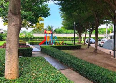 Lush green outdoor area with children