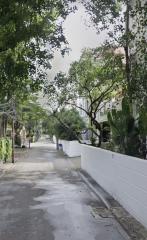 Tree-lined residential street with sidewalks and houses