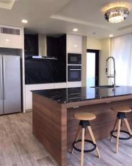 Modern kitchen with stainless steel appliances and breakfast bar