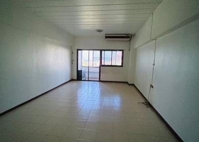 Spacious unfurnished interior of a building with tile flooring and air conditioning