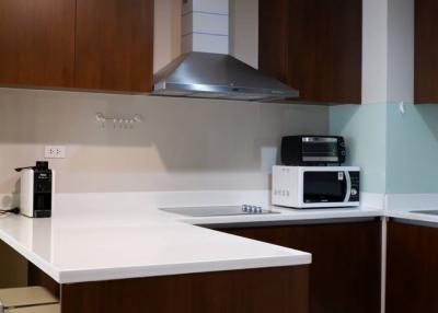 Modern kitchen with stainless steel appliances and wooden cabinets