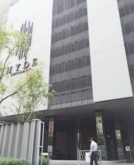 Modern residential building entrance with a person walking in front