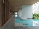 Modern building hallway with floor-to-ceiling windows overlooking a pool