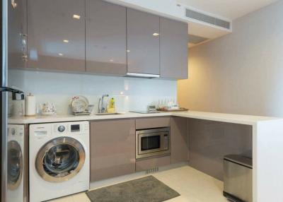 Modern compact kitchen with built-in appliances and ample cabinet space