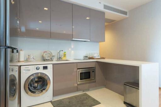 Modern compact kitchen with built-in appliances and ample cabinet space