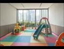 Children's playroom with colorful interlocking floor mats and various play equipment in a high-rise building