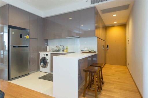 Modern kitchen with integrated appliances and breakfast bar