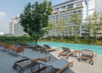 Residential building with outdoor pool and lounge chairs