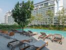 Residential building with outdoor pool and lounge chairs