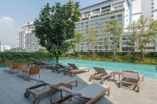 Residential building with outdoor pool and lounge chairs