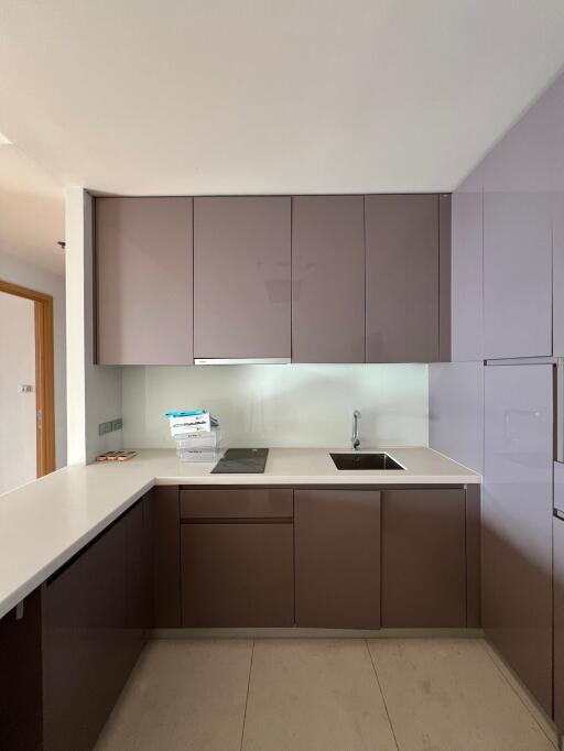 Modern kitchen with sleek brown cabinetry and white countertops