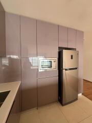 Modern kitchen with stainless steel refrigerator and built-in appliances