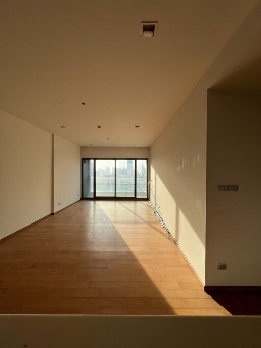 Spacious living room with natural light and hardwood floors