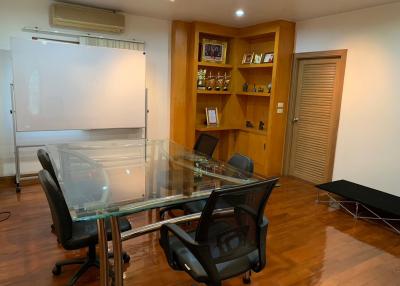 Spacious office room with a meeting table and chairs