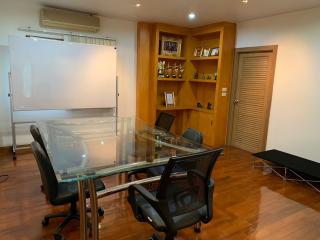 Spacious home office with a large desk and bookshelf