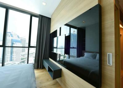 Modern bedroom with large windows and city view