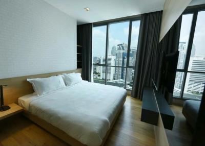 Modern bedroom with a beautiful city view through large windows