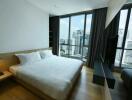 Modern bedroom with a beautiful city view through large windows