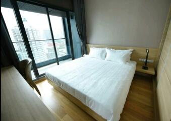 Modern bedroom with large windows and city view