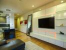 Modern living room interior with mounted television and comfortable seating