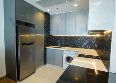 Modern kitchen with stainless steel appliances and black tile backsplash