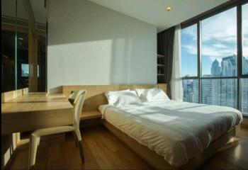 Modern bedroom with large windows and city view