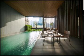 Modern outdoor area with swimming pool and seating arrangement