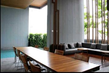 Spacious patio area with large dining table adjacent to a pool