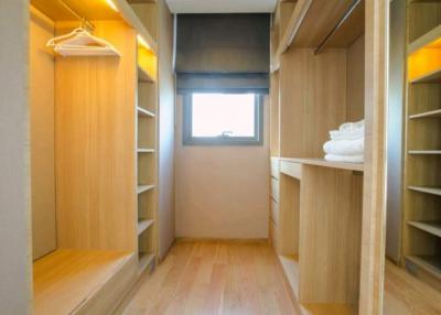 Spacious walk-in closet with built-in shelves and drawers