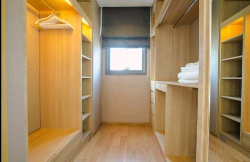 Spacious walk-in closet with built-in shelves and drawers