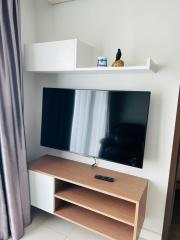 Modern living room interior with mounted television and minimalist shelving