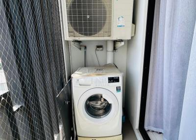 Compact laundry space with washing machine and air conditioning units