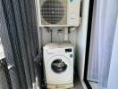 Compact laundry space with washing machine and air conditioning units