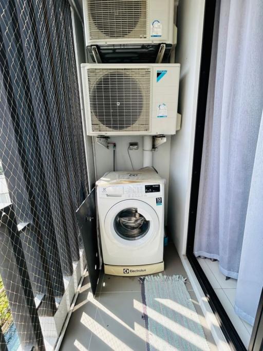Compact laundry space with washing machine and air conditioning units