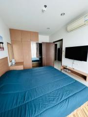 Cozy bedroom with modern amenities and wooden accents